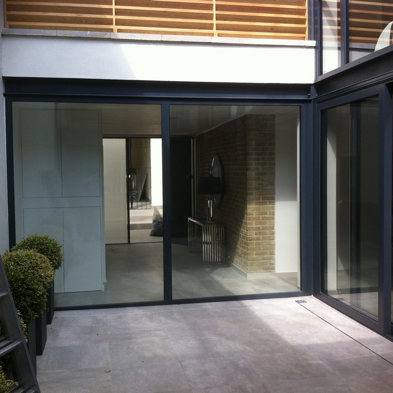 Floor-to-ceiling sliding doors opening to courtyard in Clapton