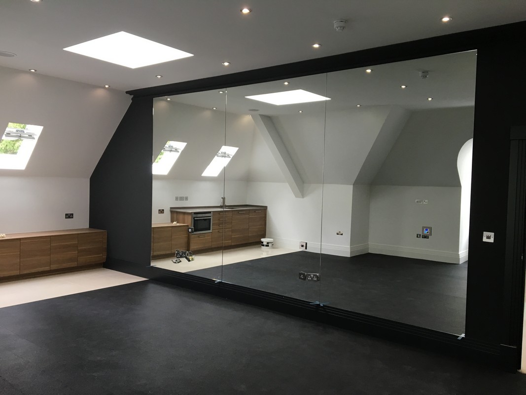 Frameless glass wall dividing loft conversion in Clapton