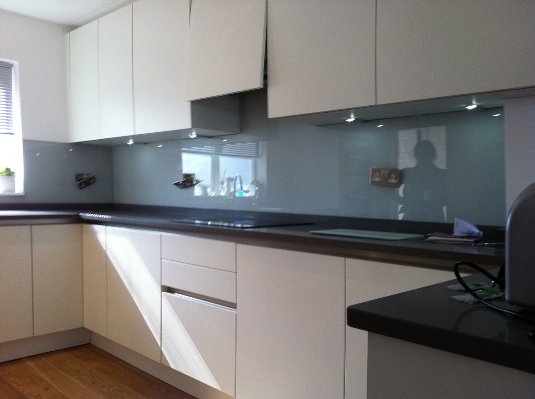 Grey glass kitchen splashback with LED lighting in Clapton