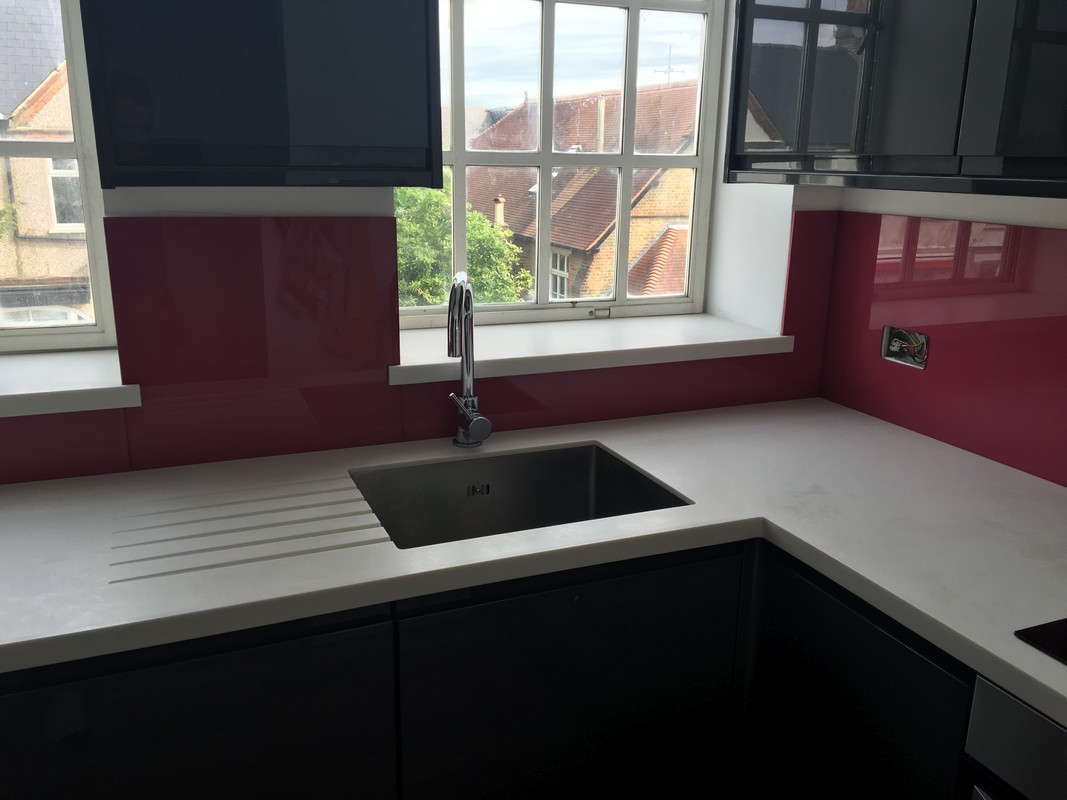 Deep plum coloured glass splashback in modern Clapton kitchen
