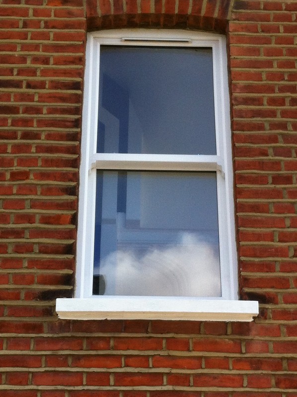 uPVC sash window on Victorian red brick house in Clapton